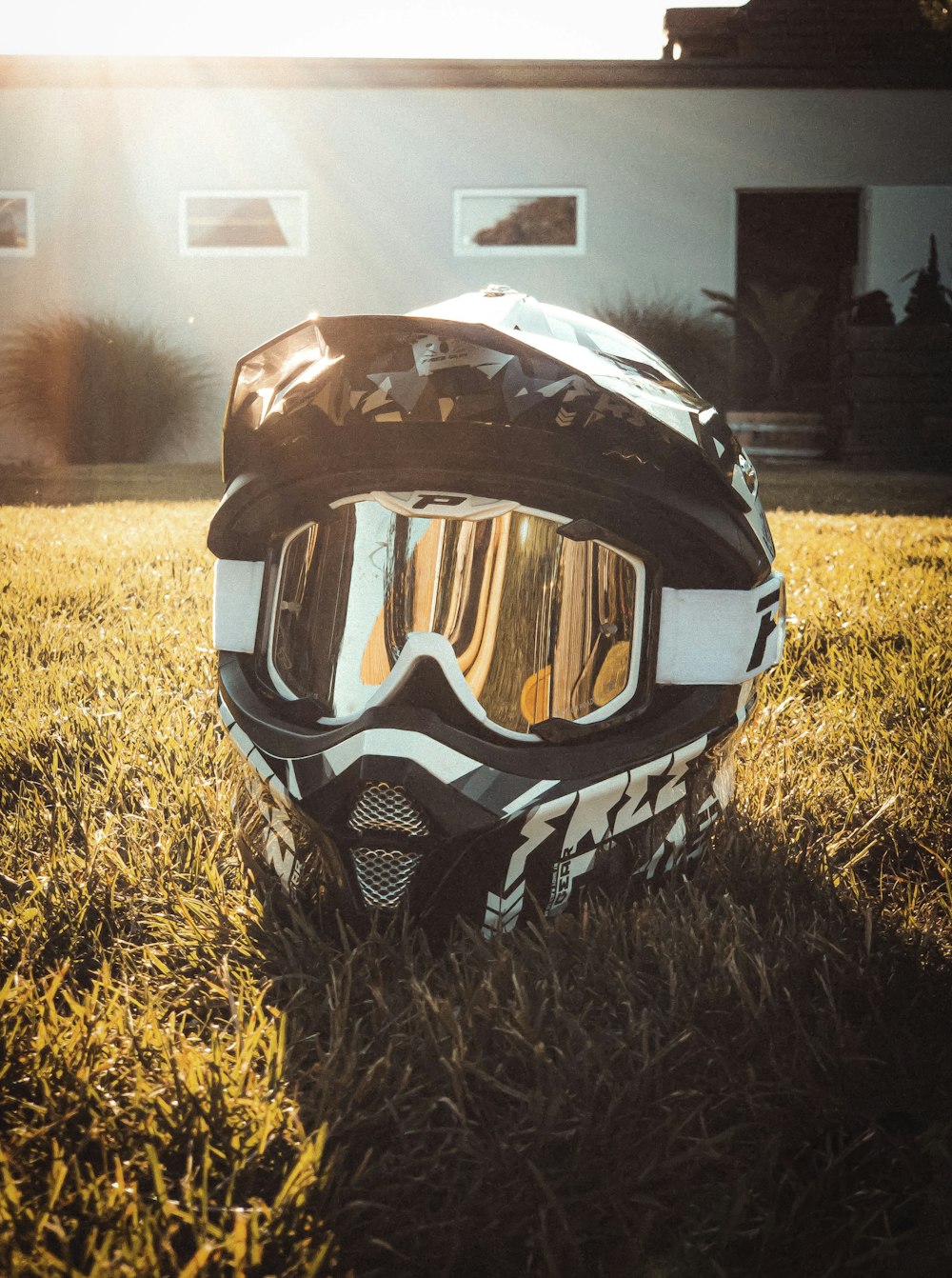 black and gray helmet on grass during daytime