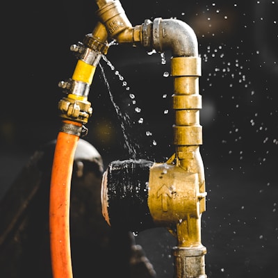 gold-colored faucet close-up photography