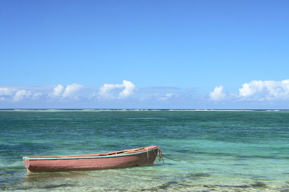 white boat on shore during daytime