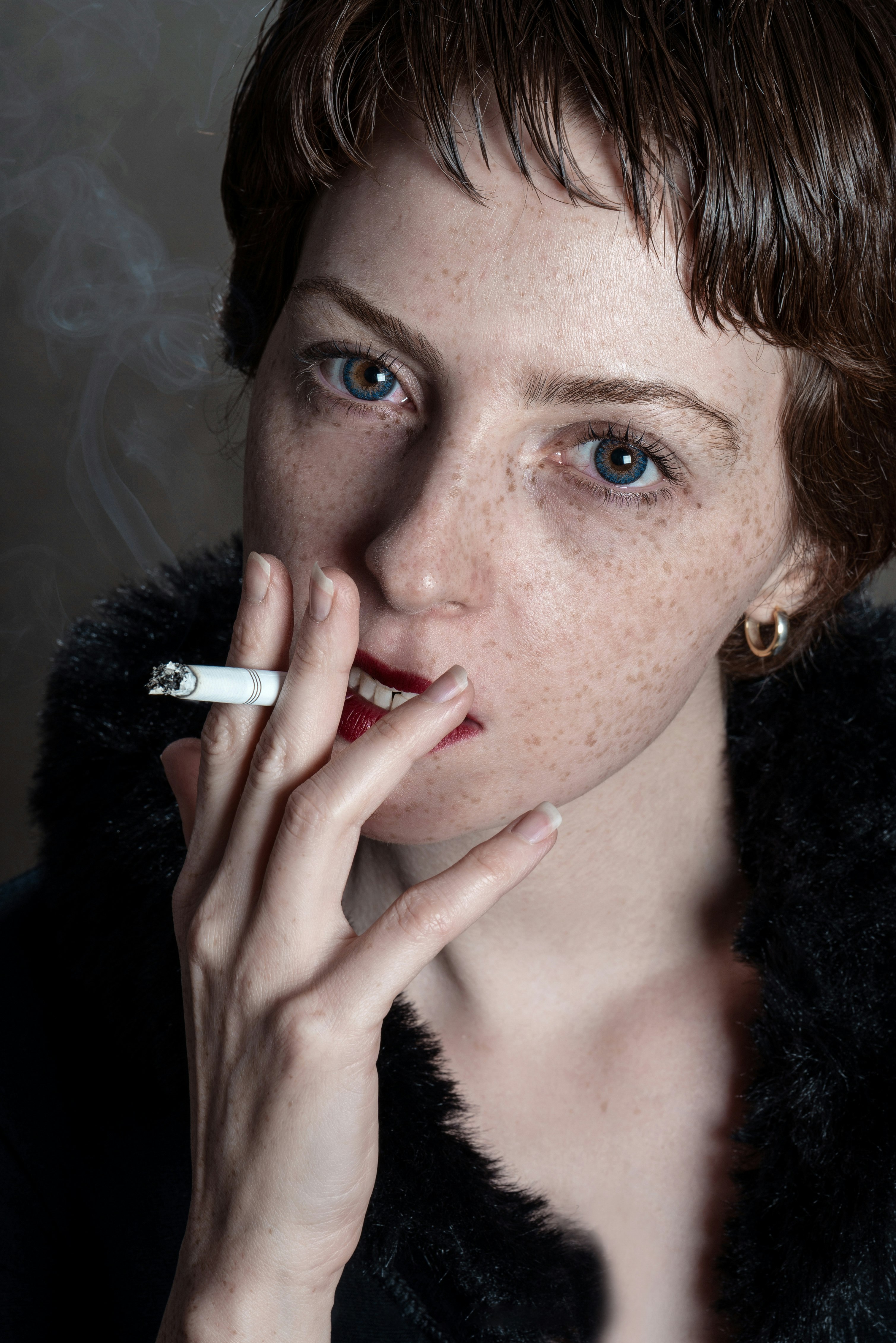 woman wearing black fur coat smoking