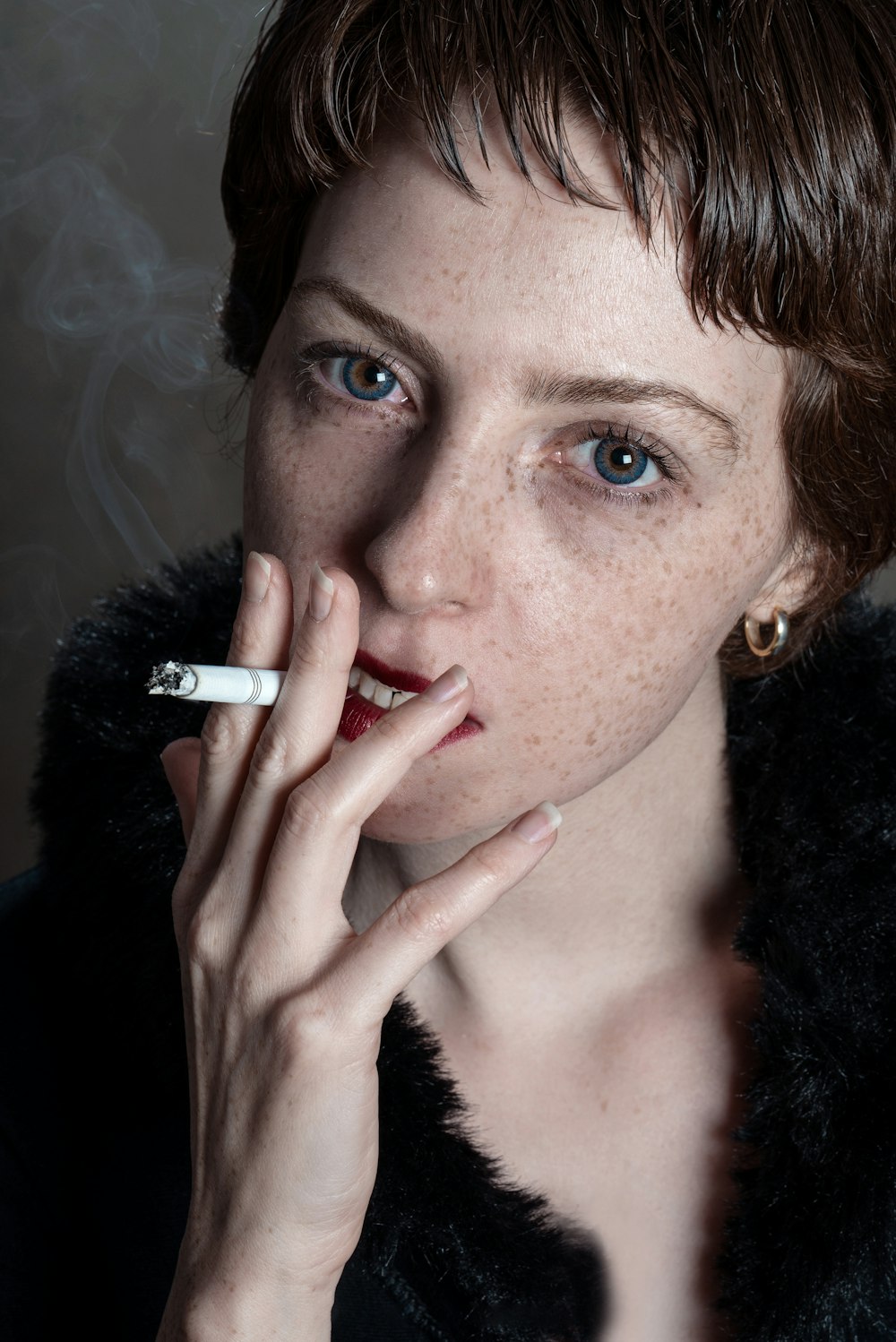 woman wearing black fur coat smoking