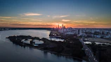 A cityscape of Honolulu with a courthouse in the foreground at sunset.