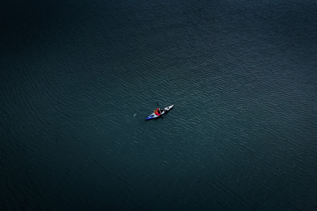 aerial photo of man kayaking on sea