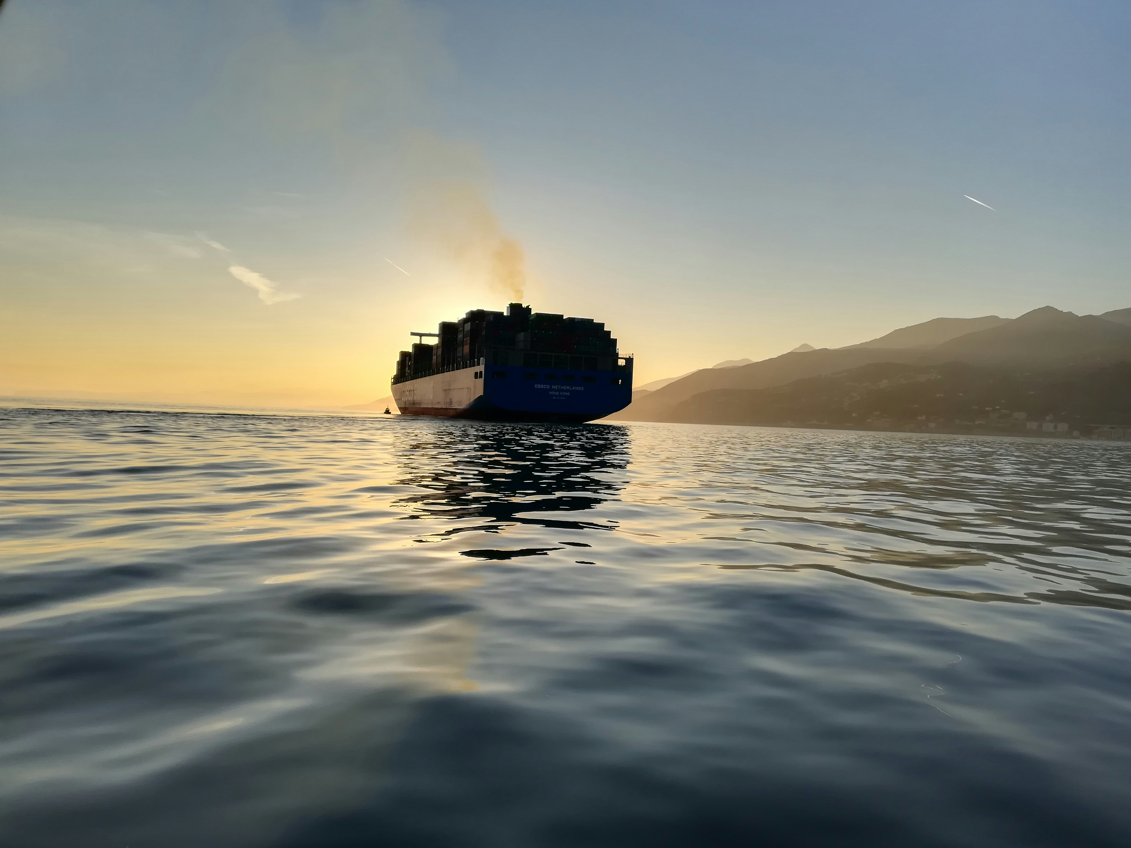 cargo ship on sea during golden hou