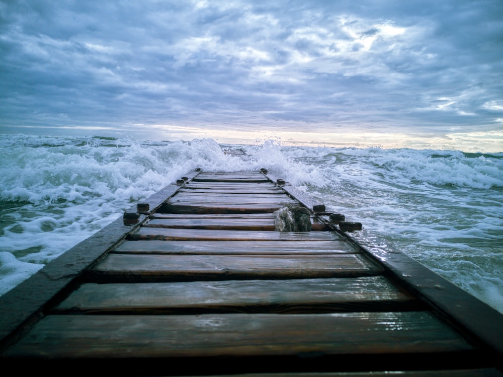 dock under cloudy sky during daytime