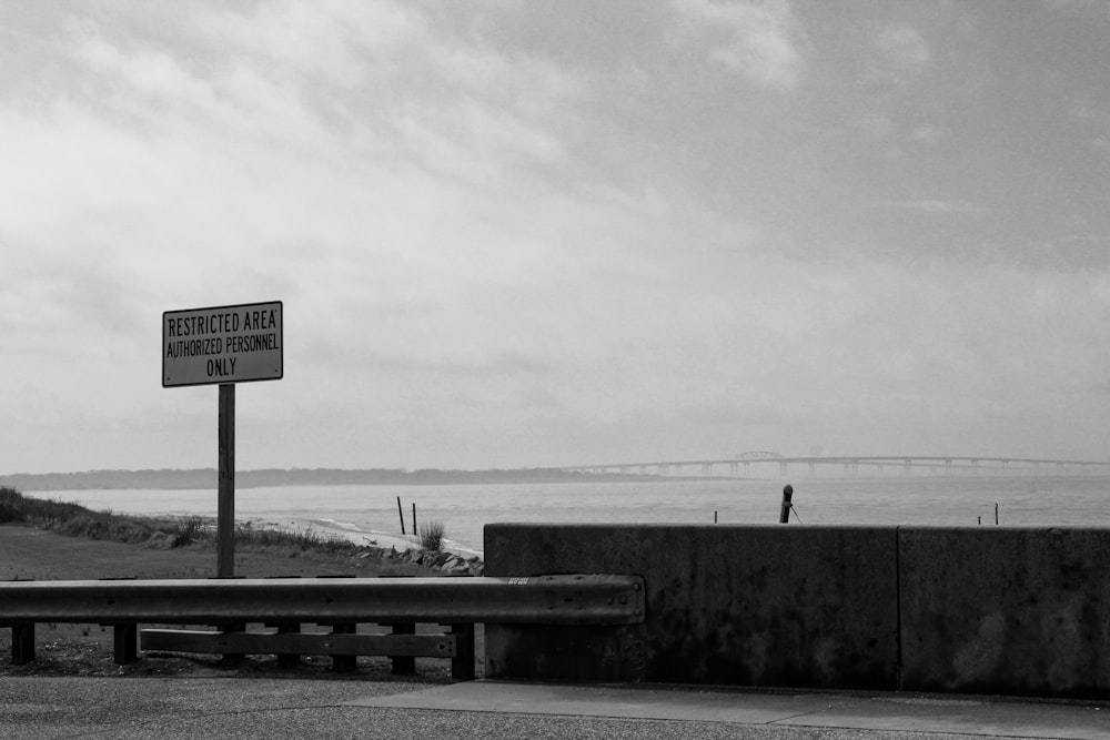 road sign board grey-scale photgraphy