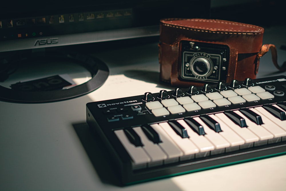 black electronic keyboard near black camera