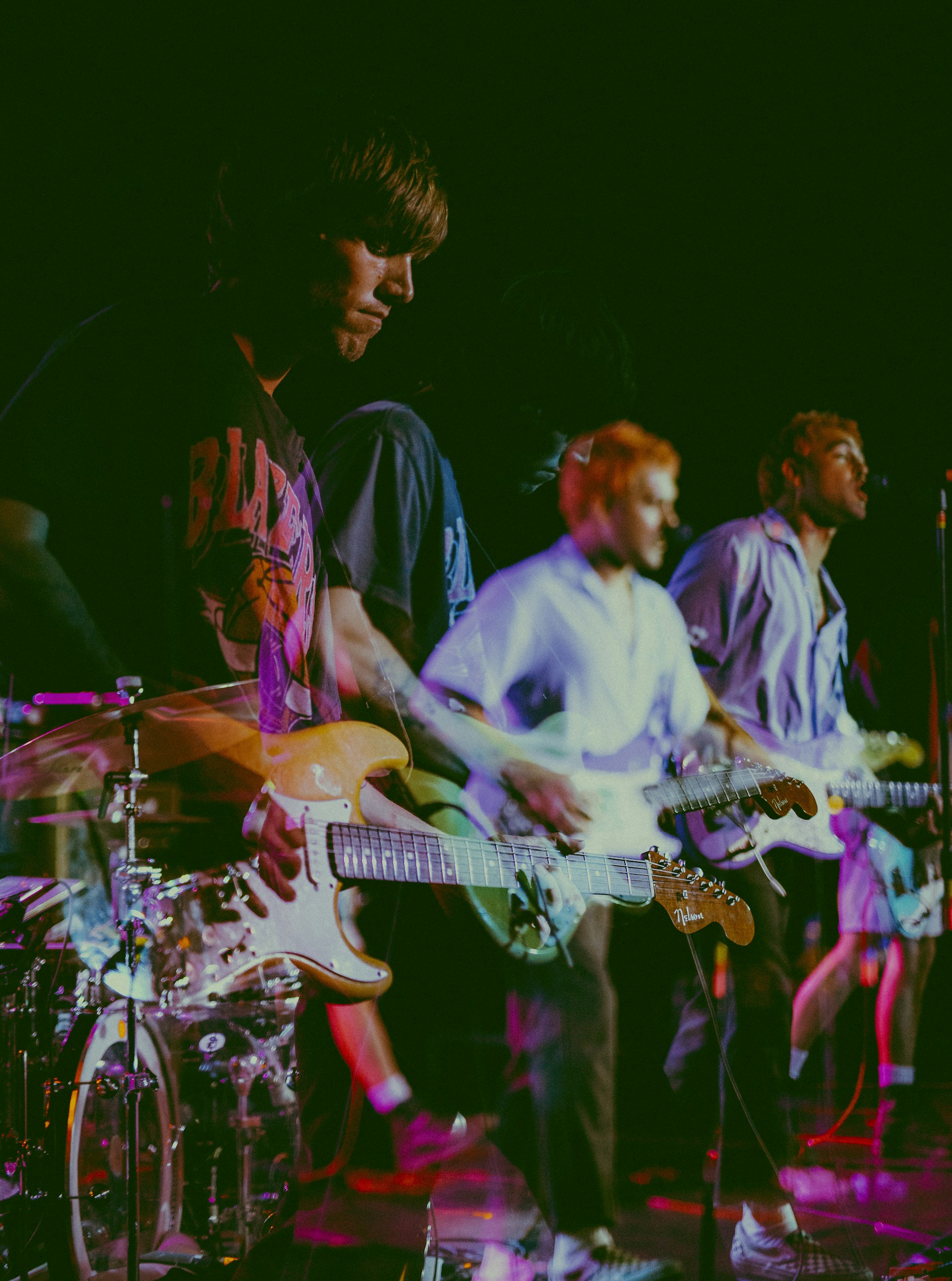 Abstract motion blur of band members during a dynamic performance, emphasizing the site’s clean and fluid design aesthetic.