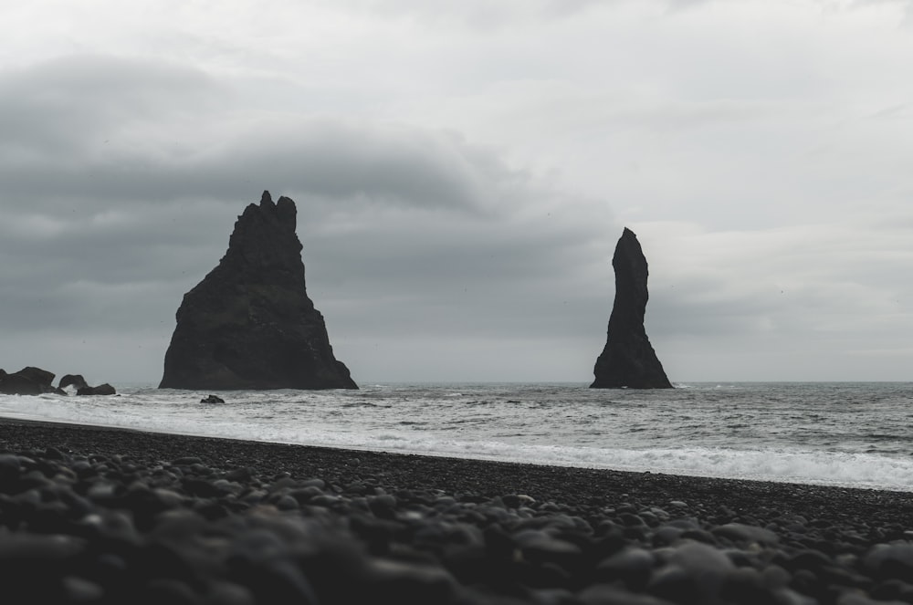 two rock formations at the shore