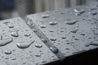 Illustration of water droplets rolling off a solar panel with lotus effect nano protection