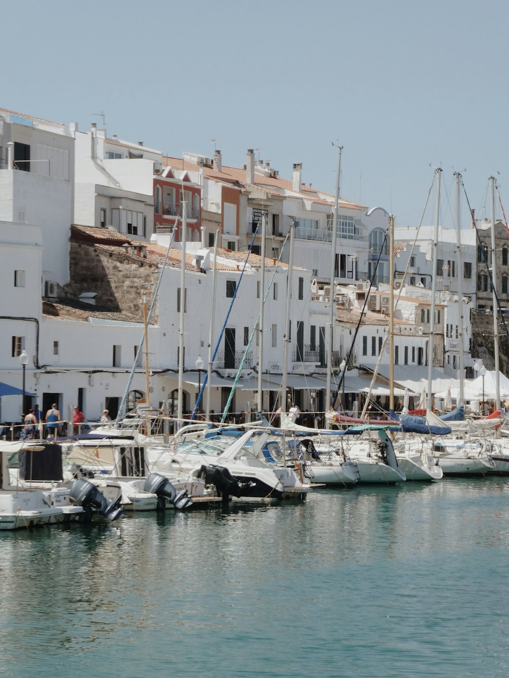 white boats on body of water during daytime