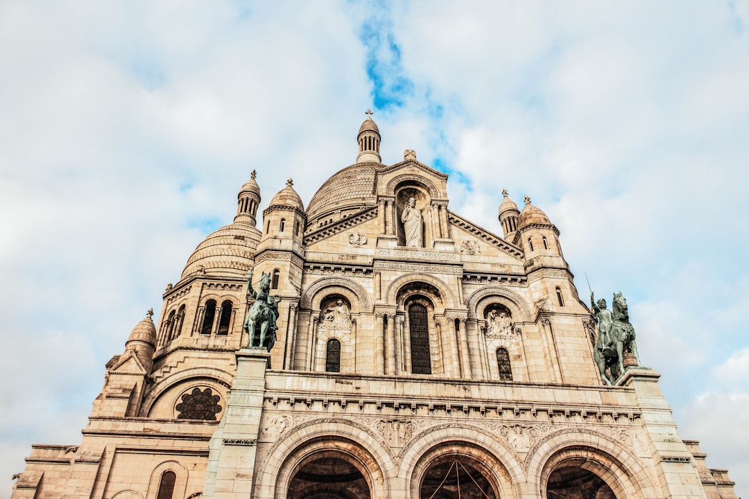 brown cathedral under grey cloudy sky,