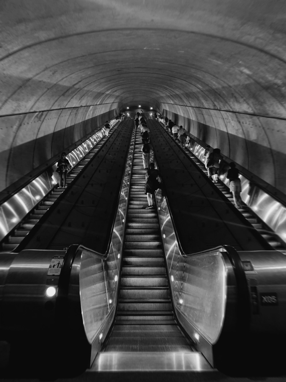 grayscale photography of escalators with no people