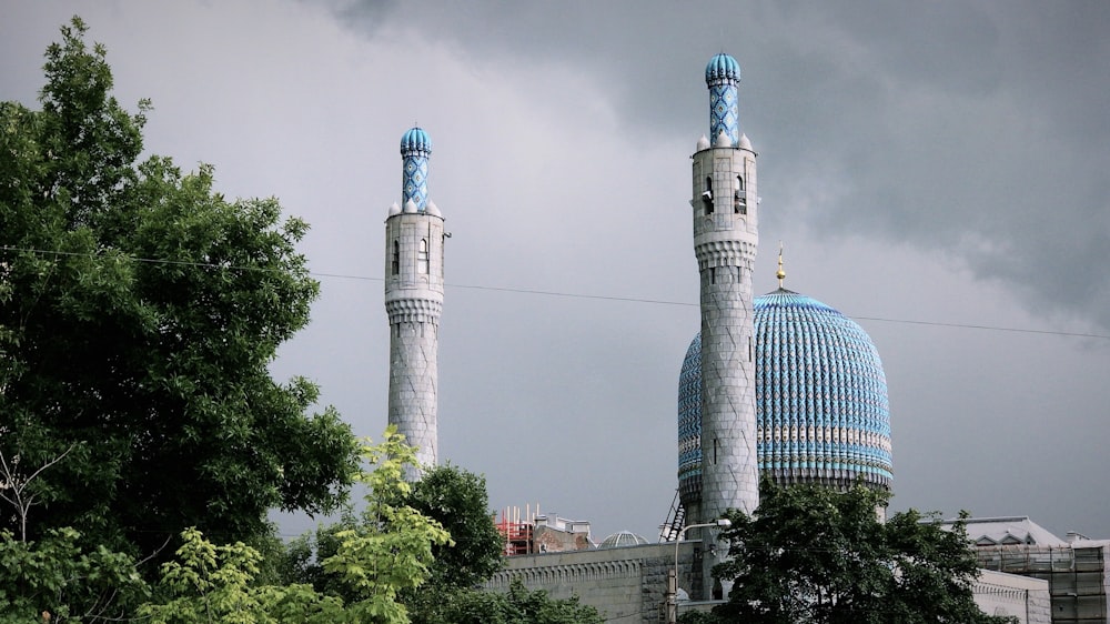 white and blue concrete building under cloudy sky