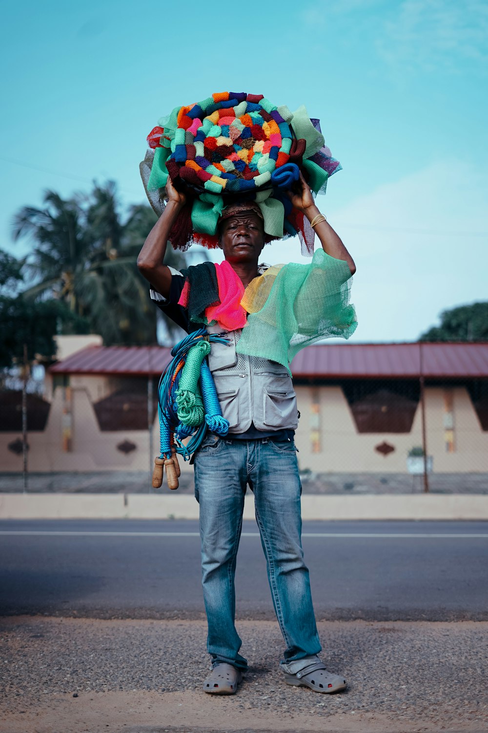 man standing and carrying multicolored hat