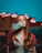 A happy young woman vaping with neon-colored lights in the background.