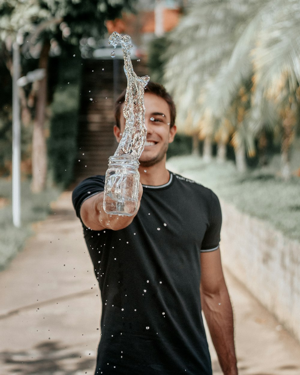 selective focus photography of man throwing water