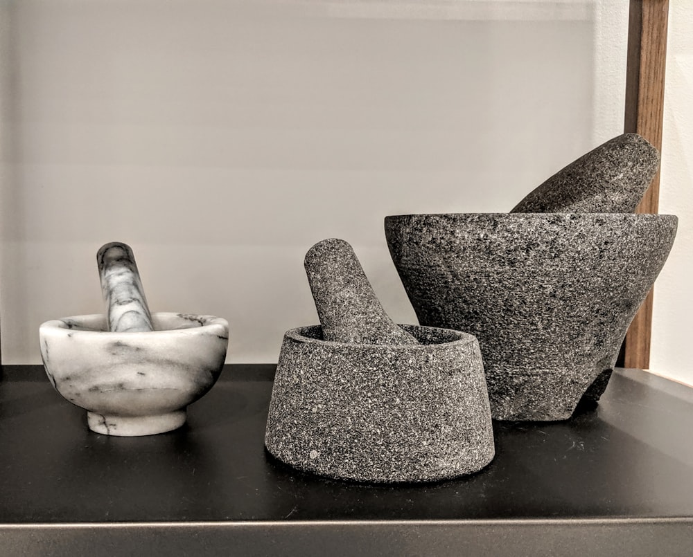 three mortal and pestles on table