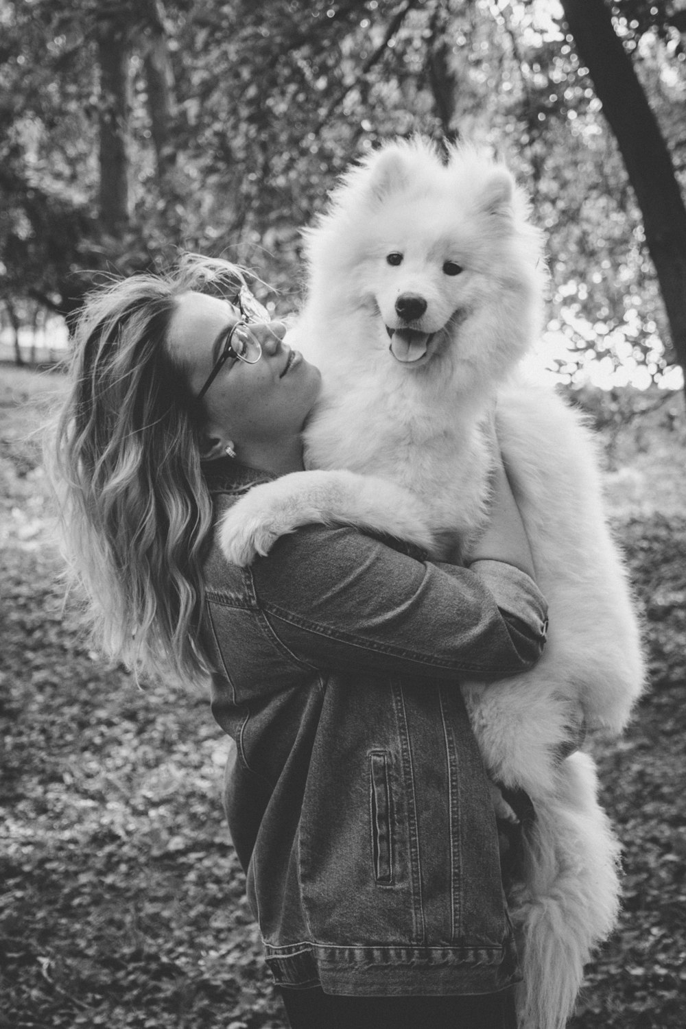 woman carrying dog