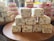 Stacks of nougat and layered jelly desserts are arranged on wooden platters. The nougat pieces are square, featuring visible nuts throughout, while the jelly desserts display colorful layered stripes.