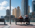 two people sitting on wooden bench during daytime