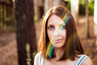 selective focus photography of woman under trees appealing teams background