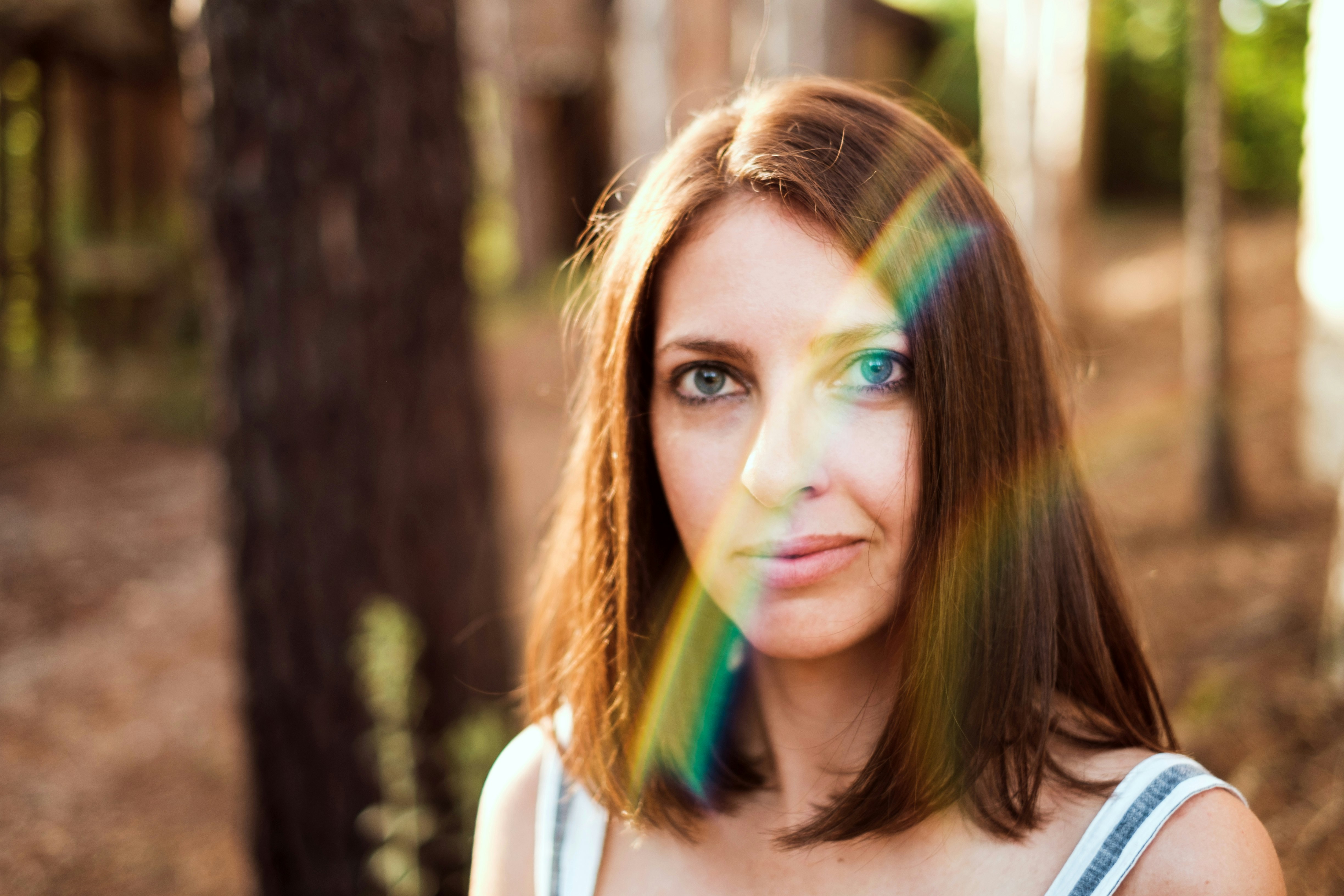 selective focus photography of woman under trees