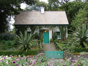 brown and white 1-storey house surrounded by trees