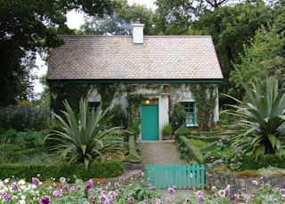 brown and white 1-storey house surrounded by trees