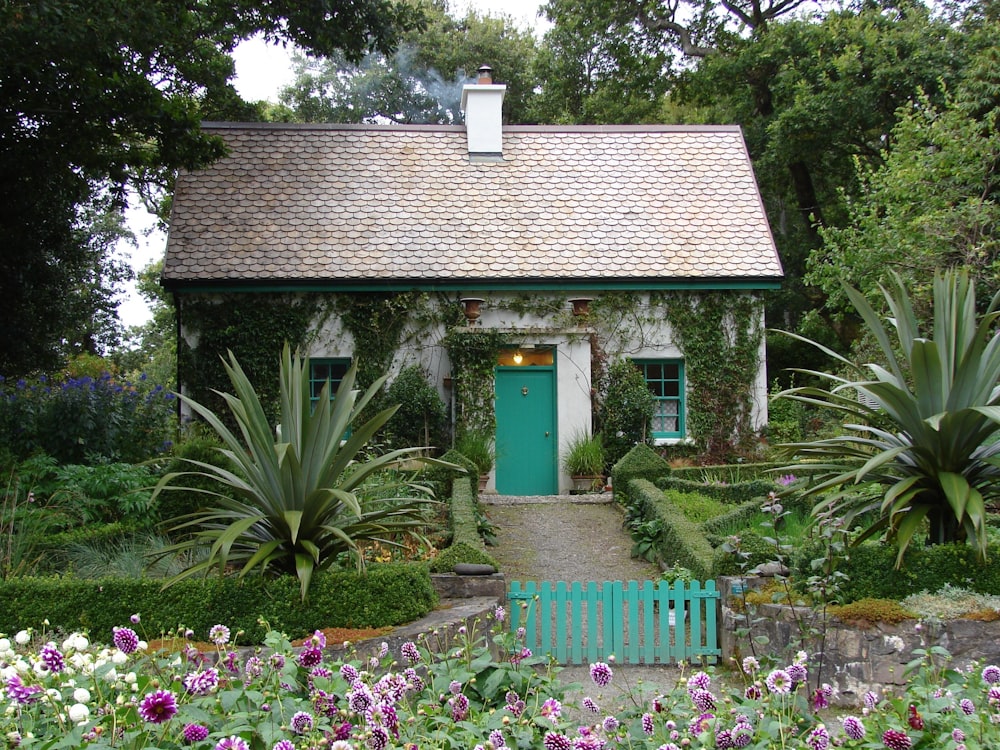 brown and white 1-storey house surrounded by trees