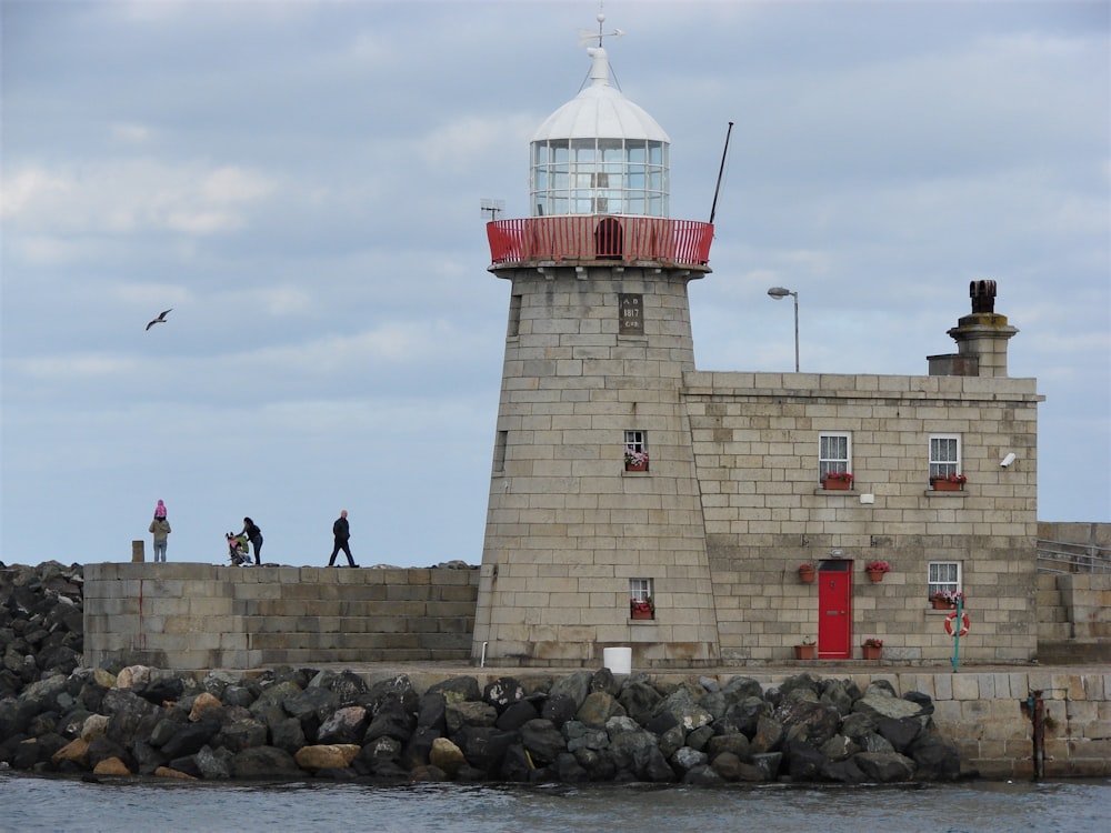 gray concrete building with light house during daytime