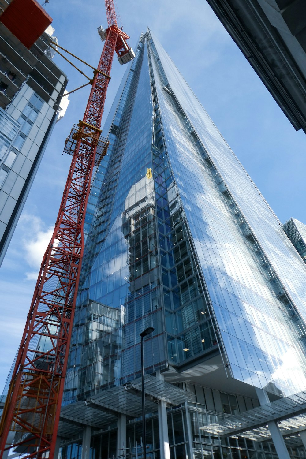 high rise building and red tower crane