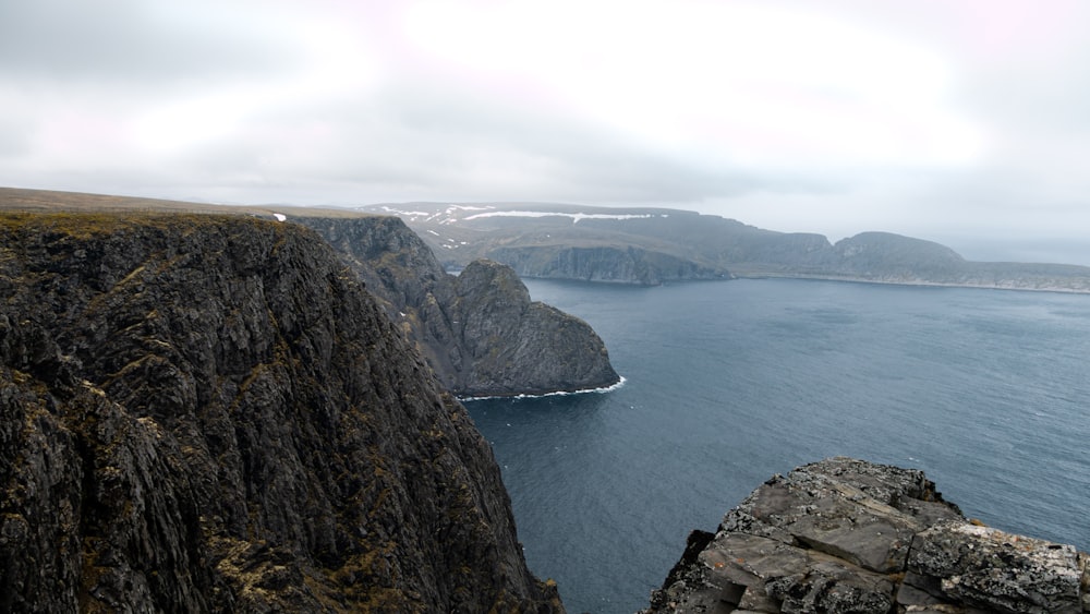 blue sea viewing mountain under white skies