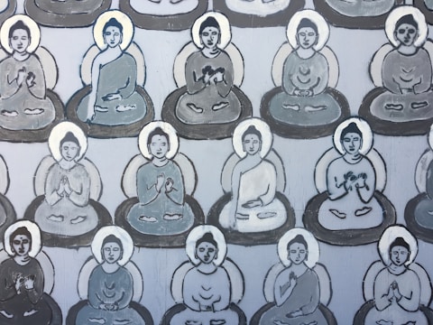 Multiple stylized figures seated in meditative postures are featured in a repeating pattern across the canvas. Each figure is encircled by a subtle halo and depicted in shades of gray and white, suggesting a calm and serene atmosphere. The figures exhibit a variety of hand gestures, commonly associated with meditation or spiritual practice.