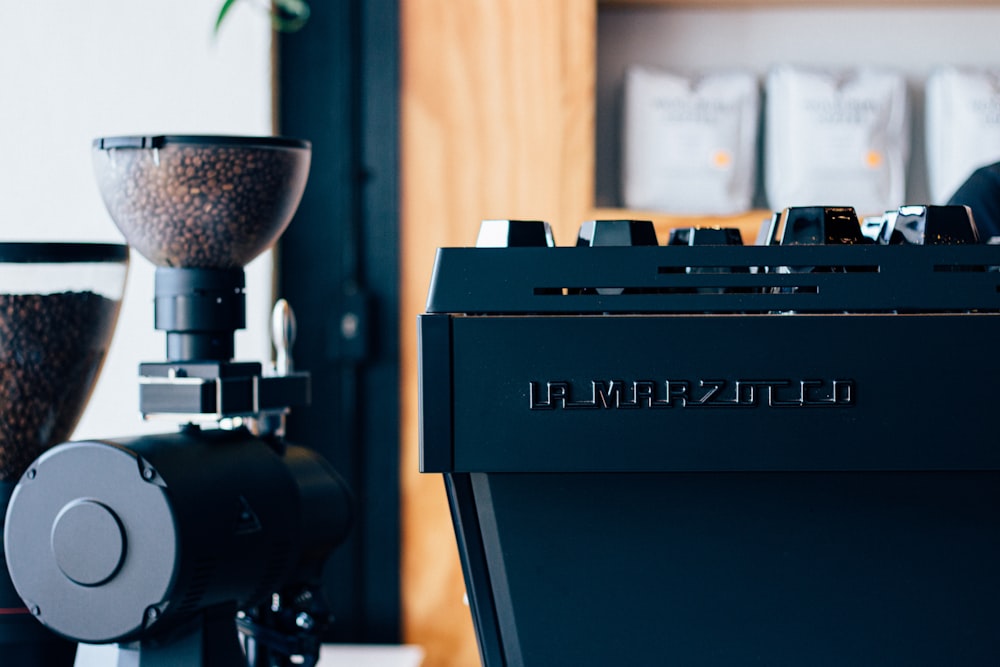 a coffee machine sitting next to a potted plant