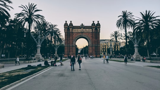 people near brown concrete gate during daytime in Arc de Triomf Spain