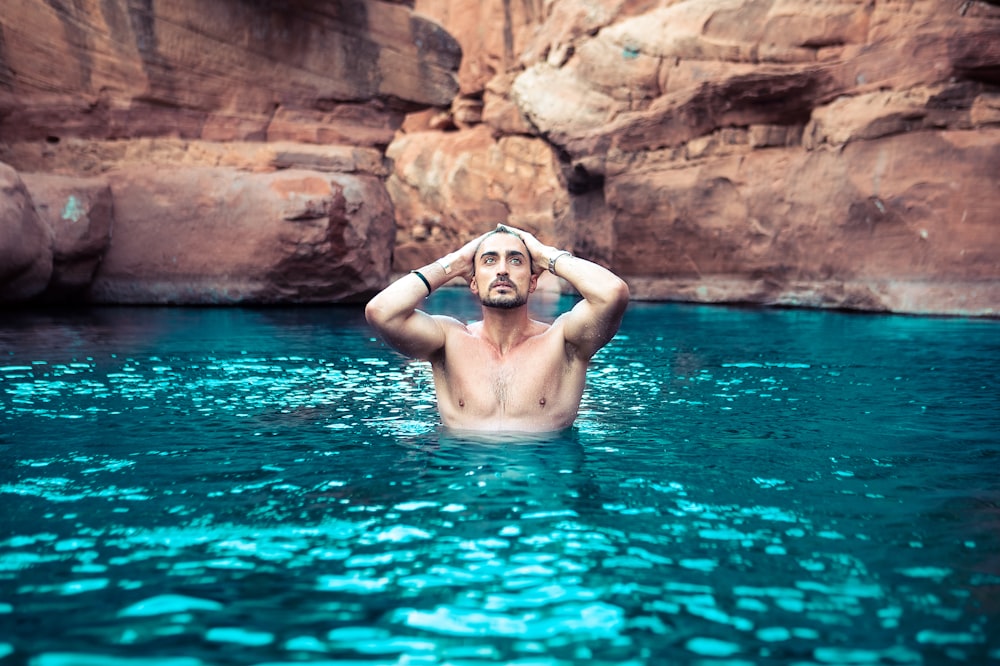 topless man on body of water