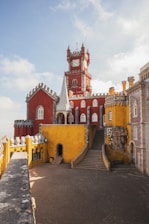 yellow and red concrete building under clear blue sky