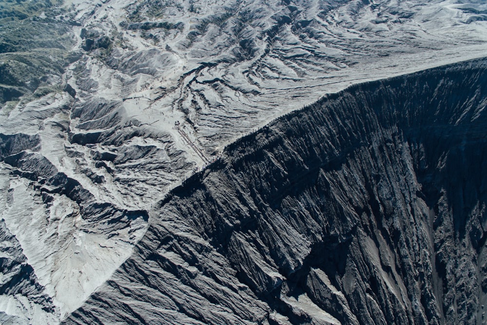 an aerial view of a mountain range in the snow