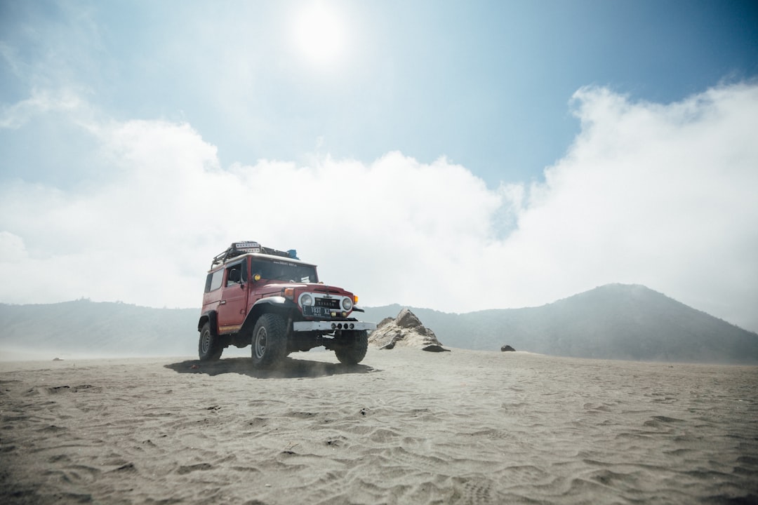 low-angle photography of a wrangler vehicle in desert