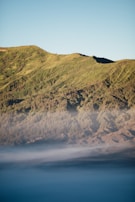 A peaceful mountain scene with mist rising in the early morning.