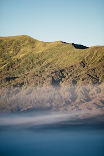 A peaceful mountain scene with mist rising in the early morning.