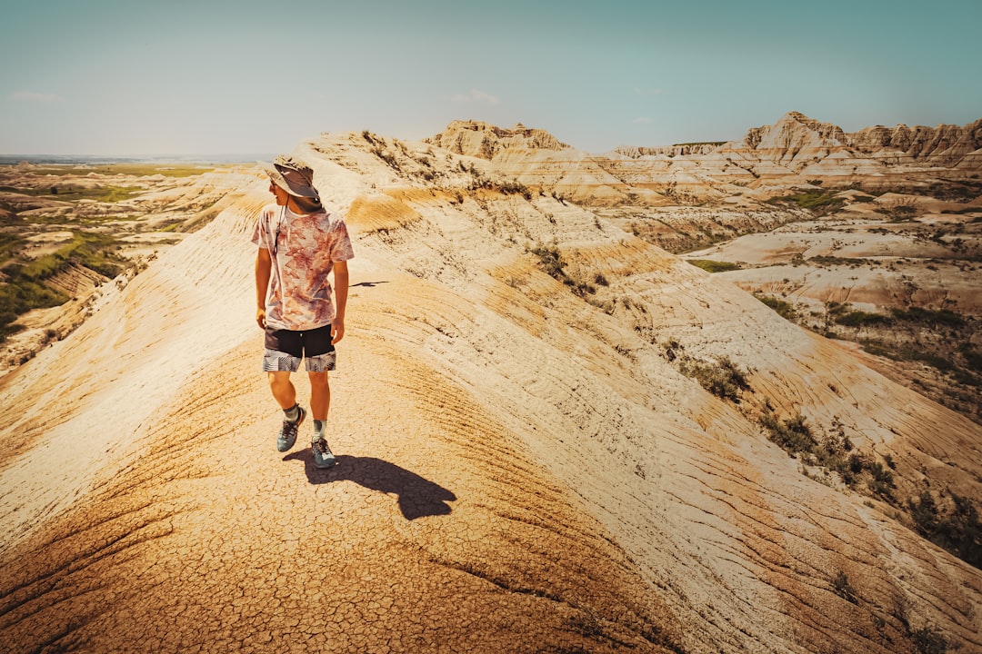 man walking on a rocky mountain,