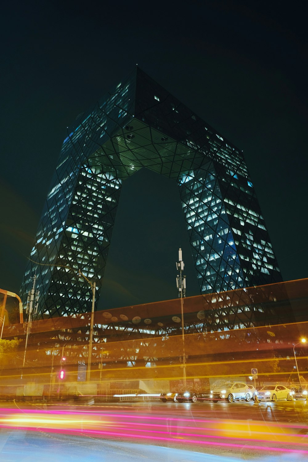 cars on road and lighted building at night