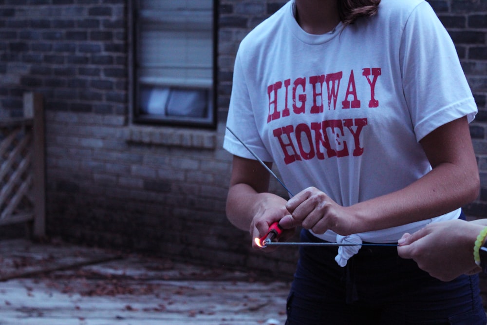 woman holding red handled blow torch