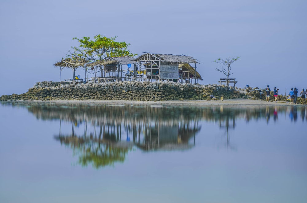 cottages surrounded with body of water during daytime