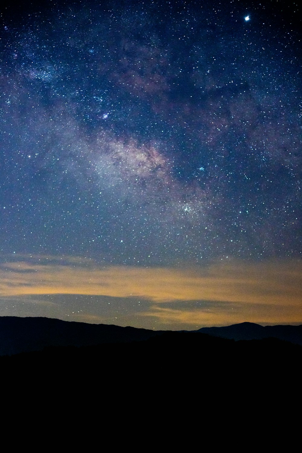 the night sky is filled with stars and clouds