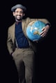 smiling man carrying blue globe