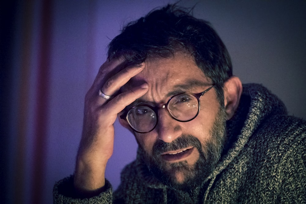 man in grey sweater and pair of black framed eyeglasses