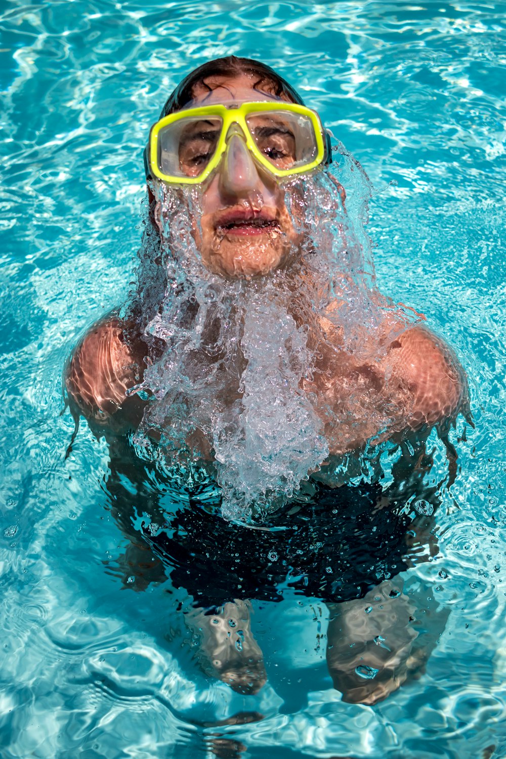 woman with goggles in the pool at daytime